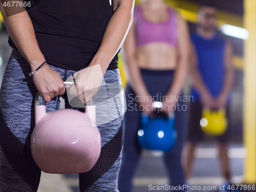 Image of athletes doing exercises with kettlebells