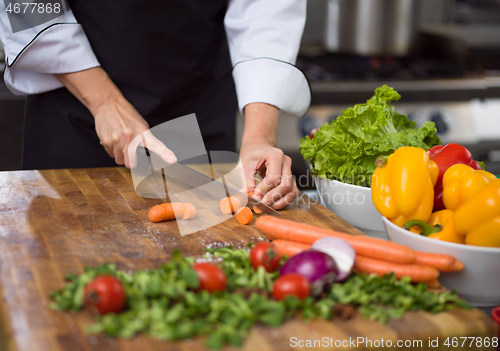 Image of chef hands cutting carrots