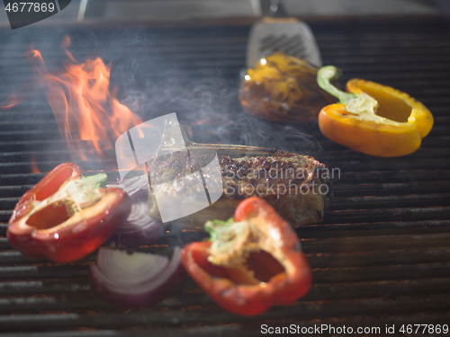 Image of steak with vegetables on a barbecue