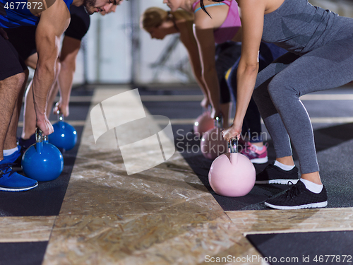 Image of athletes doing exercises with kettlebells