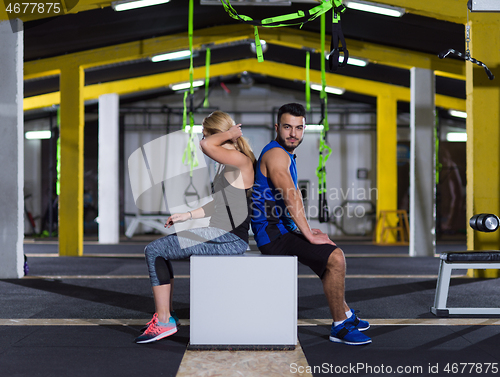 Image of portrait of athletes working out  jumping on fit box