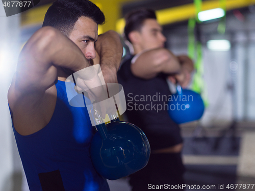 Image of athletes doing exercises with kettlebells