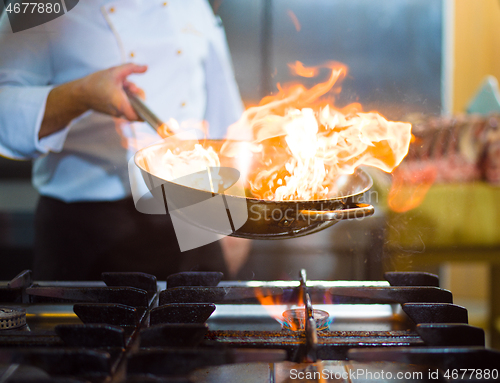 Image of Chef doing flambe on food