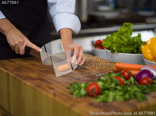 Image of chef hands cutting carrots