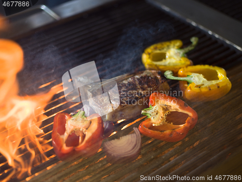 Image of steak with vegetables on a barbecue