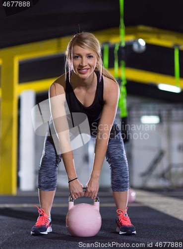 Image of woman exercise with fitness kettlebell