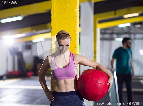 Image of portrait of woman with red crossfitness ball