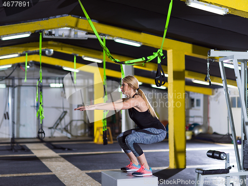 Image of woman working out  jumping on fit box