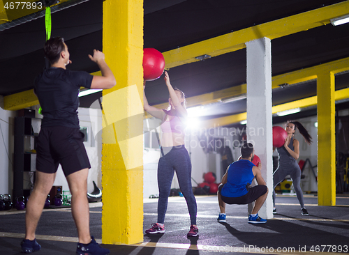 Image of young athletes working out with medical ball