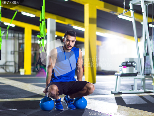 Image of Young strong man doing pushups