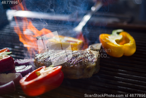Image of steak with vegetables on a barbecue