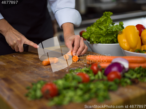 Image of chef hands cutting carrots