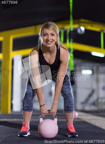 Image of woman exercise with fitness kettlebell