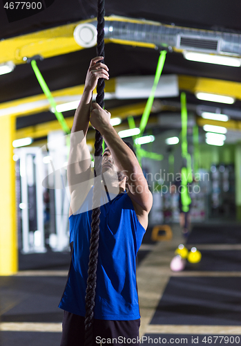 Image of man doing rope climbing