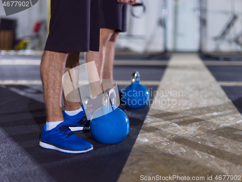 Image of athletes doing exercises with kettlebells