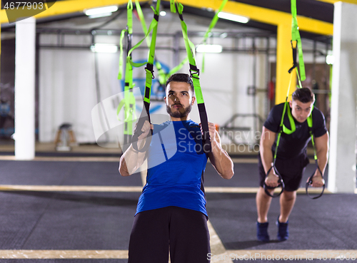 Image of men working out pull ups with gymnastic rings