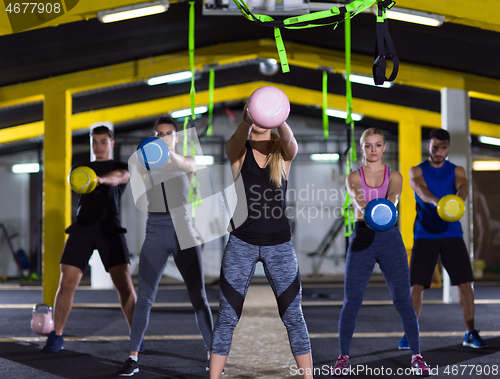 Image of athletes doing exercises with kettlebells