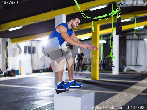 Image of man working out jumping on fit box