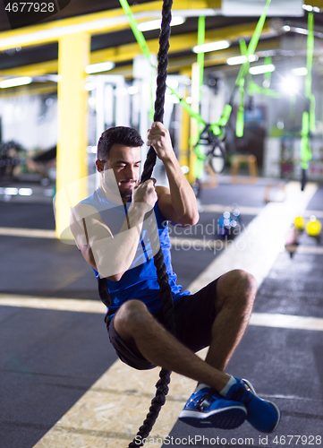 Image of man doing rope climbing