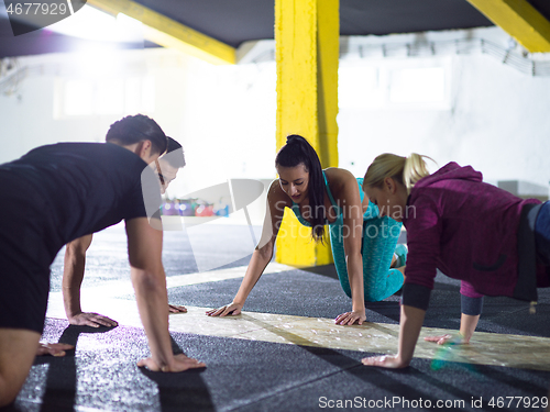 Image of young healthy people doing pushups