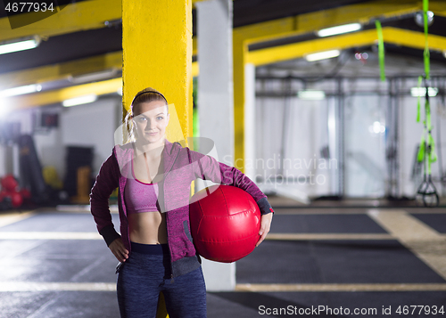 Image of portrait of woman with red crossfitness ball