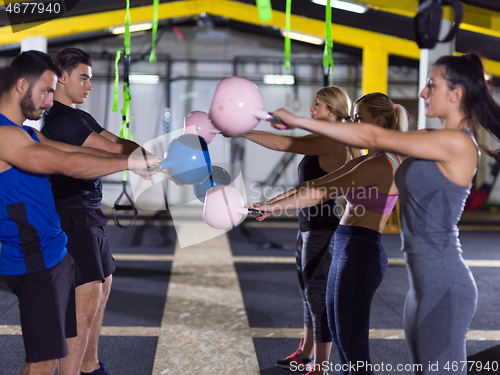 Image of athletes doing exercises with kettlebells