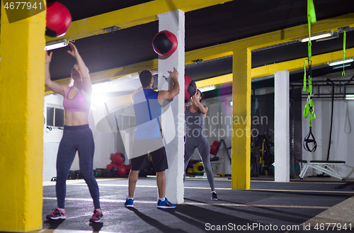 Image of young athletes working out with medical ball