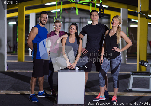 Image of portrait of athletes working out  jumping on fit box