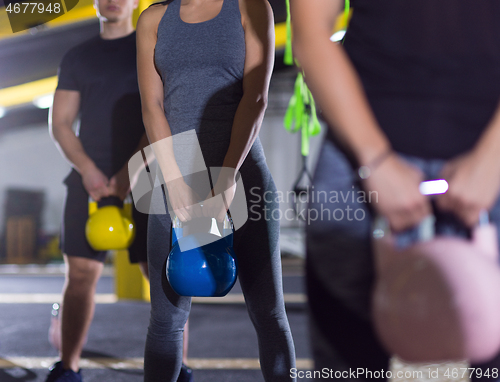 Image of athletes doing exercises with kettlebells