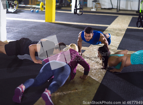 Image of young healthy people doing pushups