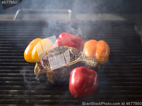 Image of steak with vegetables on a barbecue