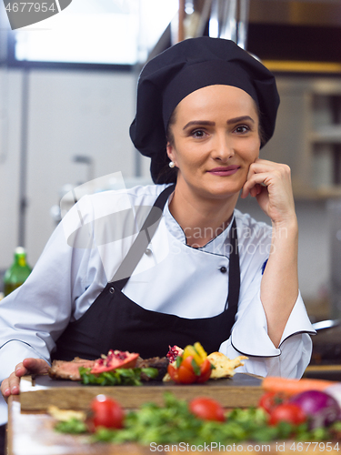 Image of female Chef preparing beef steak