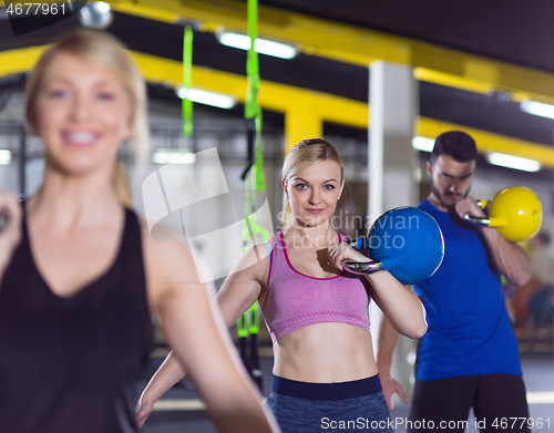 Image of athletes doing exercises with kettlebells