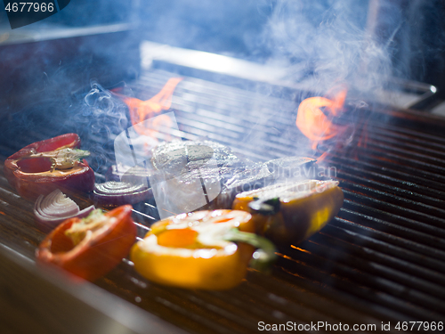 Image of steak with vegetables on a barbecue