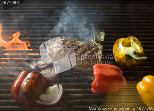 Image of steak with vegetables on a barbecue