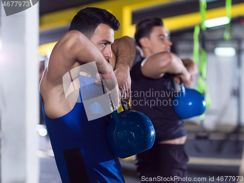 Image of athletes doing exercises with kettlebells