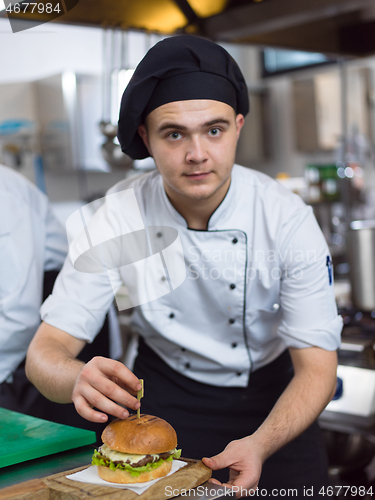 Image of chef finishing burger