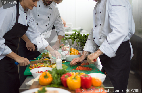 Image of team cooks and chefs preparing meals