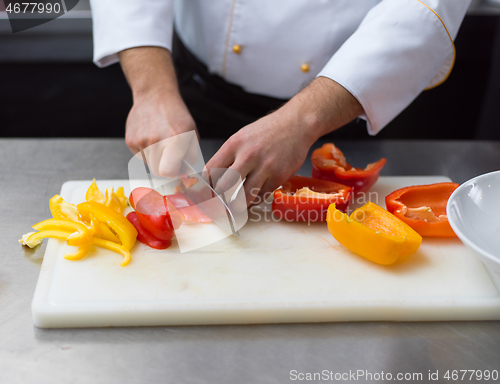 Image of Chef cutting fresh and delicious vegetables