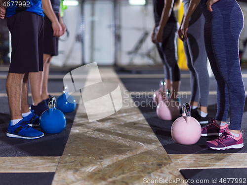 Image of athletes doing exercises with kettlebells