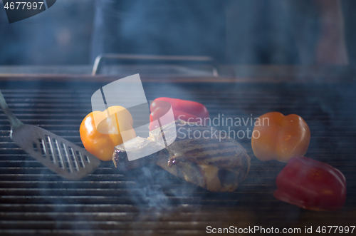 Image of steak with vegetables on a barbecue