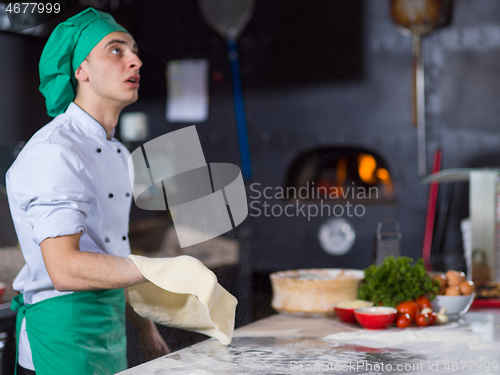 Image of chef throwing up pizza dough