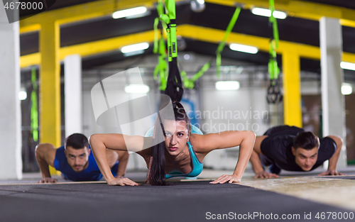 Image of young healthy people doing pushups