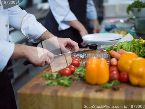 Image of Chef hands preparing marinated Salmon fish