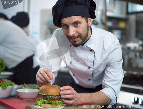 Image of chef finishing burger