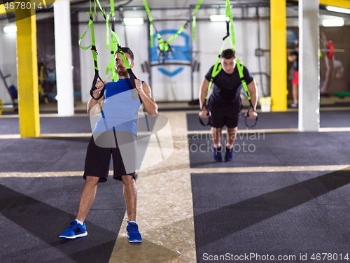 Image of men working out pull ups with gymnastic rings