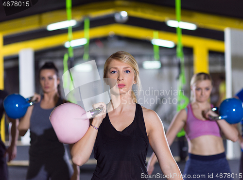 Image of athletes doing exercises with kettlebells