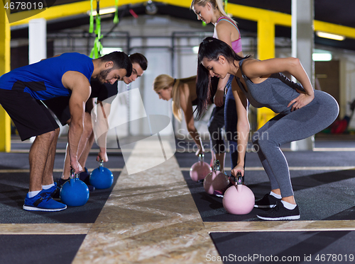 Image of athletes doing exercises with kettlebells