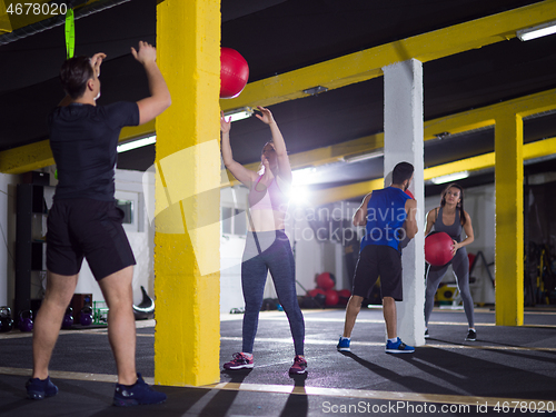 Image of young athletes working out with medical ball