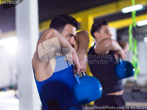 Image of athletes doing exercises with kettlebells